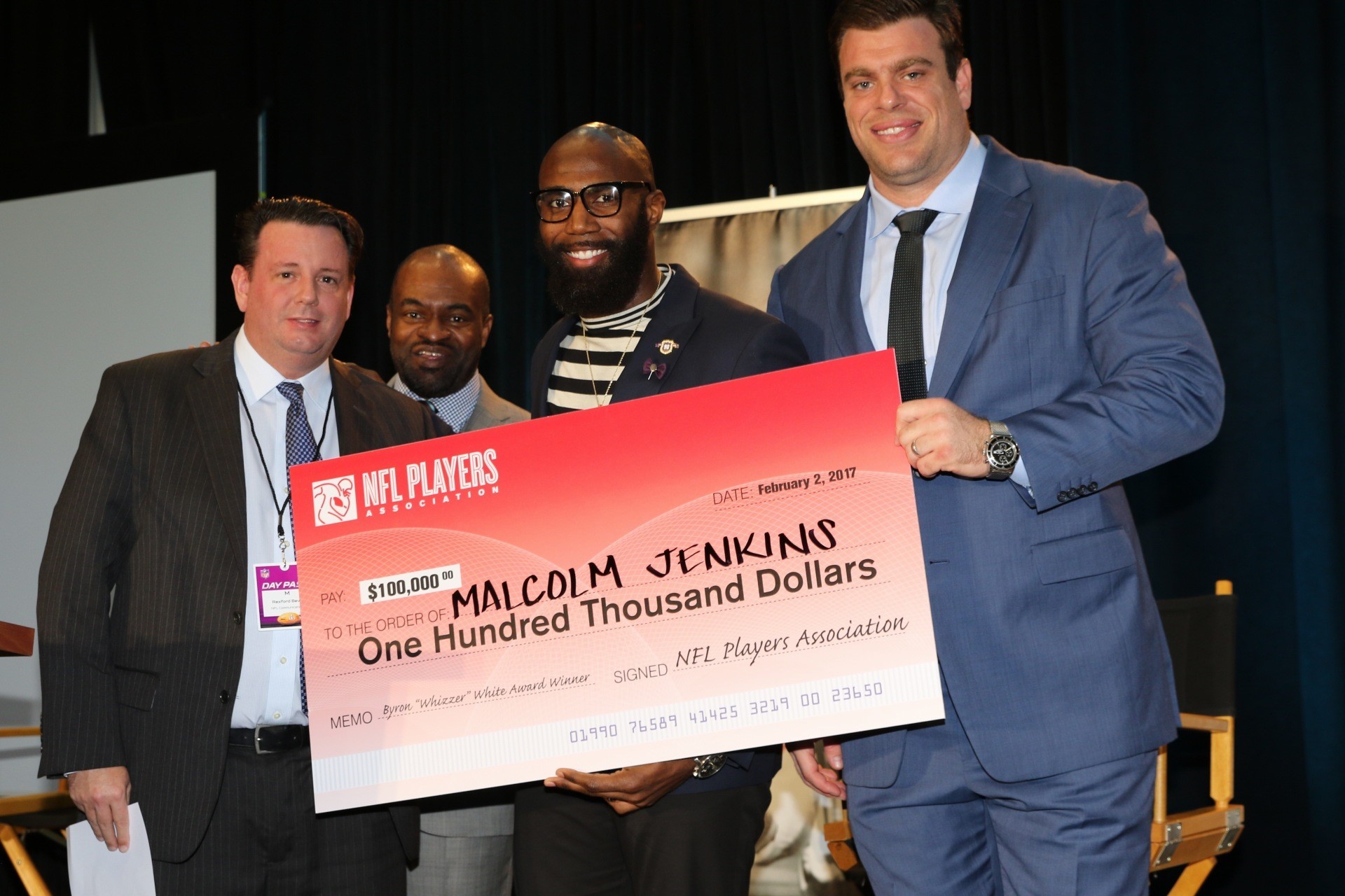 Malcolm Jenkins holding $100,000 check from the NFLPA