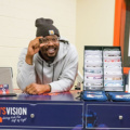 Von Miller leaning on a table for Von's Vision