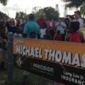 Michael Thomas speaking to the media surrounded by community members in For Pierce, Florida